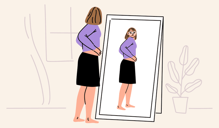 A woman looking at herself at the mirror wondering how much belly fat she has lost