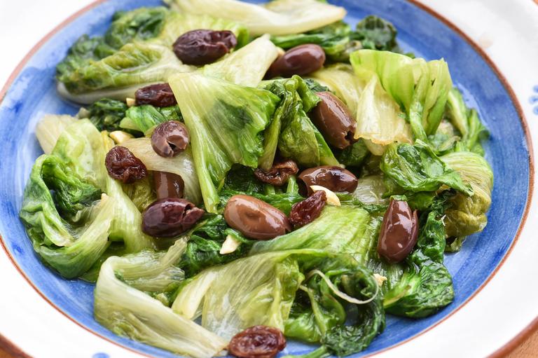 Delicious escarole salad with olives and raisins. 