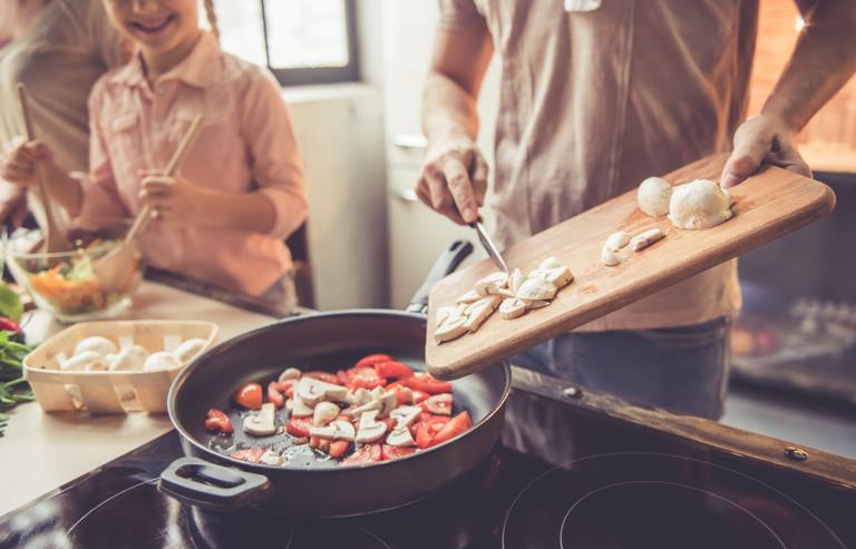 A family cooks dinner | Shutterstock