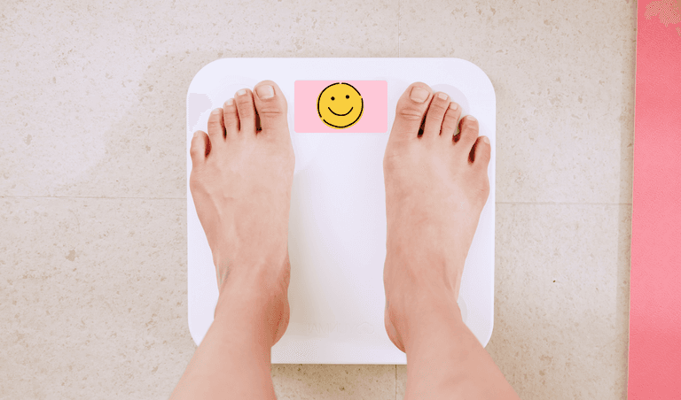 The girl on the scale sees positive results in losing excess weight