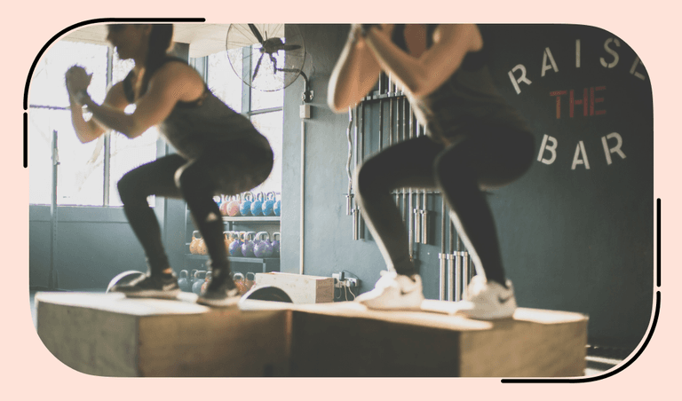 Two athletes do squats in the gym