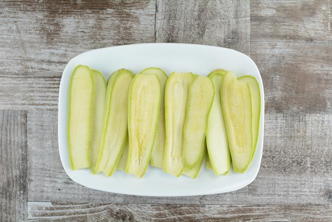 Slice zucchini lengthwise into thinner slices. The thin slices will have less water. Salt them after and let sit for 15 min. Then blot it dry with a paper towel.
