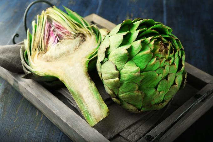 Slice the artichokes in half. Using the spoon, remove the central pith from the inside of the artichoke.
