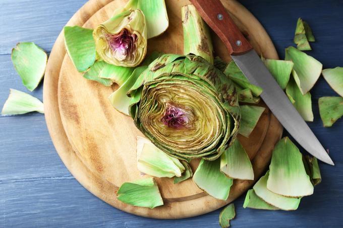Trim artichoke. Cut off the top and bottom of the stem. Pluck off all tough outer leaves.