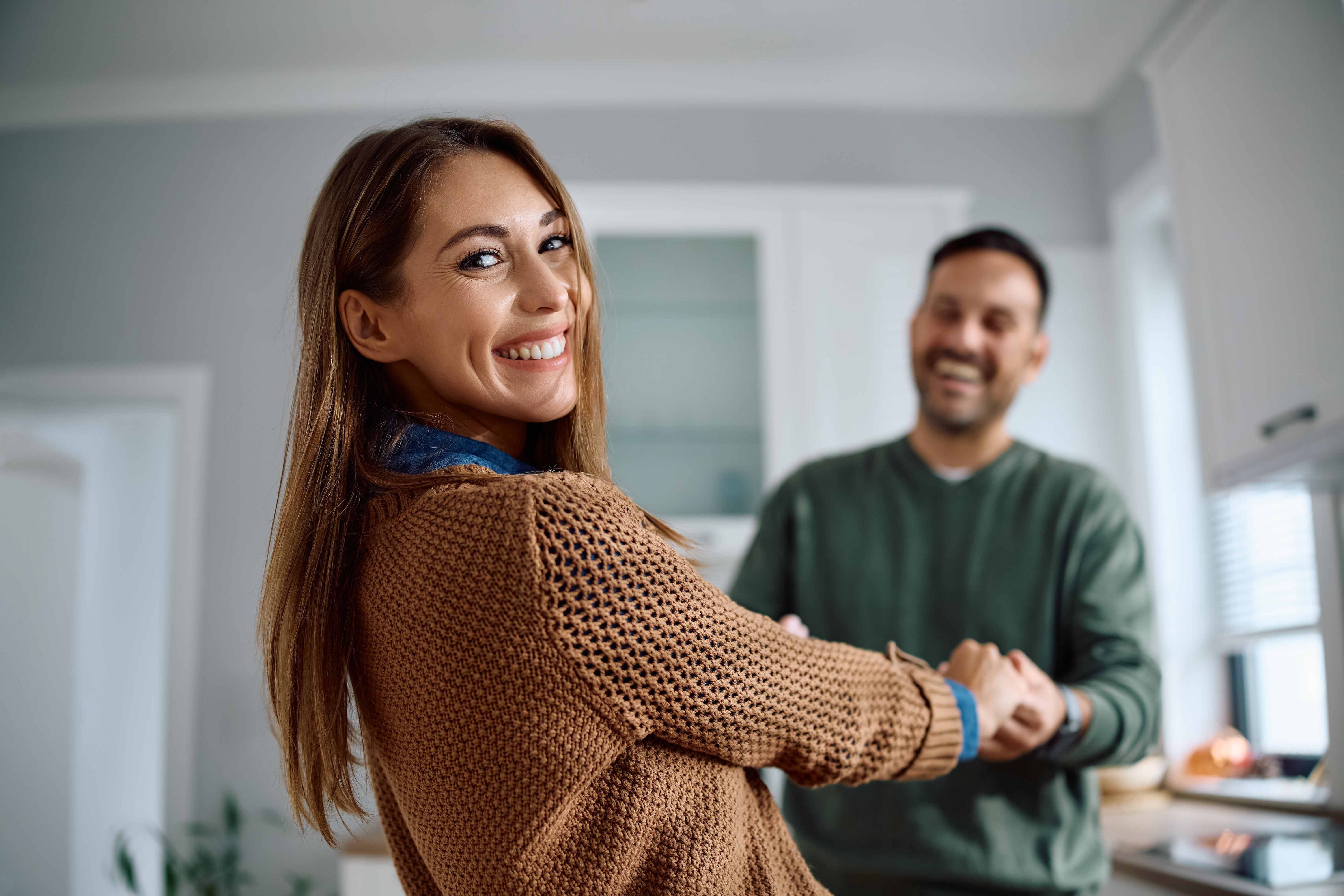 Happy couple enjoying healthy lifestyle in kitchen